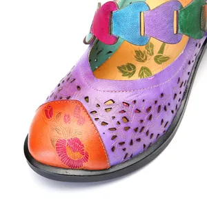 Close-up of vintage floral printed Mary Jane shoes with hollow out star patterns