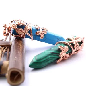 Rose gold hexagonal crystal pendants with leaf motifs in turquoise and malachite.