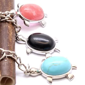 Set of three colorful turtle charms for keychains or jewelry pendants. Detailed view.