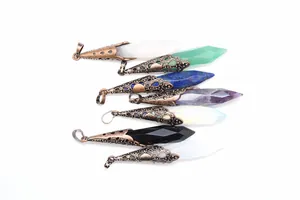 Close-up detail of various hexagonal crystal point pendants with antique bronze flower caps