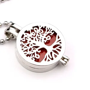Elegant hollow tree of life pendant necklace with red volcanic stone on white background
