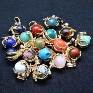 Golden dragon claw pendants with various round gemstone beads on dark background