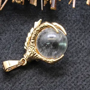Golden dragon claw necklace pendant with a clear round crystal ball jewelry piece