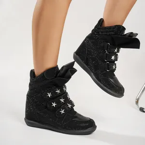 Detail showing punk style black rhinestone high-top sneakers with star rivets and velcro straps