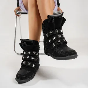 Detailed view of black punk wedge sneakers featuring star rivets and sparkling rhinestones.