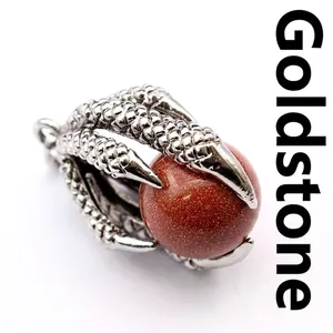 Macro detail of a vintage medieval dragon claw pendant with sparkling goldstone bead.