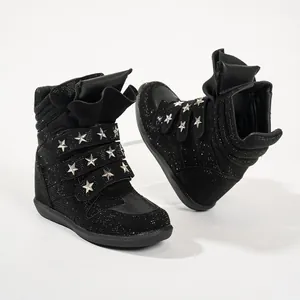 Detail view of black rhinestone high-top wedge sneakers with silver star rivets