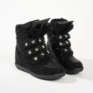 Detail of black rhinestone high-top sneakers with silver star studs and straps