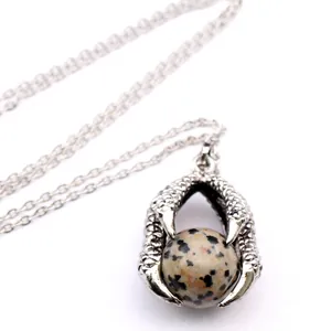 Gothic dragon claw pendant necklace detail featuring a natural Dalmatian jasper stone bead