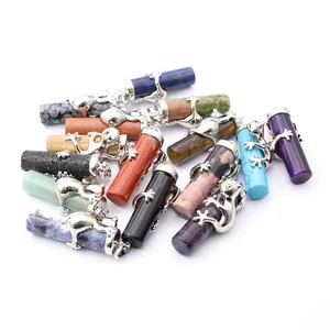 Assorted natural stone crystal pillar pendants with 3D frog charm accents on white background