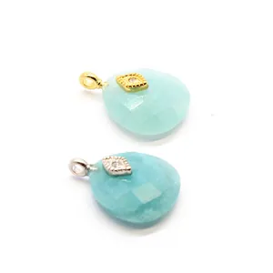 Detailed view of faceted blue Amazonite crystal pendants with gold and silver eye motifs