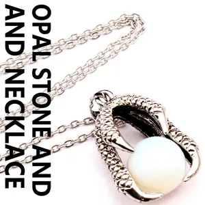 Close-up detail of vintage medieval style dragon claw pendant clutching white opal stone bead