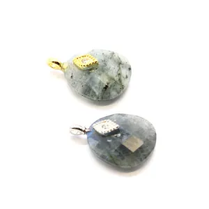 Detailed view of faceted gemstone pendants featuring gold and silver evil eye charms