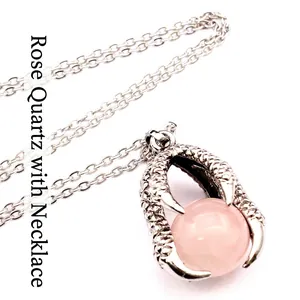 Detailed view of medieval dragon claw pendant necklace with a pink bead