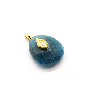 Close-up of blue amazonite crystal pendant with 24K gold plated evil eye charm