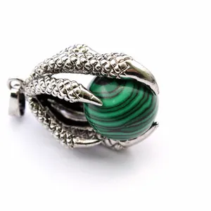 Vintage dragon claw pendant holding a green malachite stone bead in medieval style