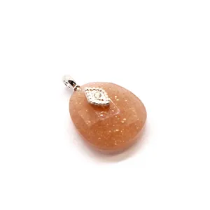 Elegant peach faceted crystal pendant featuring a silver evil eye charm detail on white background