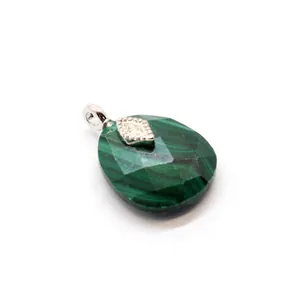 Close-up of faceted teardrop malachite pendant with intricate silver eye-shaped inlay detail