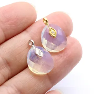 Close-up view of faceted opal crystal pendants with gold and silver plated eye details.