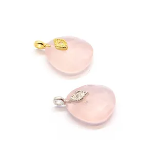 Faceted pink rose quartz crystal pendant with decorative golden and silver evil eye
