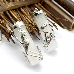 Close-up of white crystal pendants with intricate silver dragon and phoenix filigree