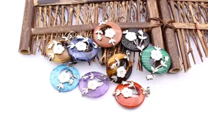 Detailed view of multi-color gemstone donut pendants with elegant silver floral overlays