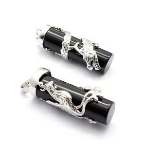 Detailed view of silver dragon and phoenix patterns on black cylindrical stone pendants.