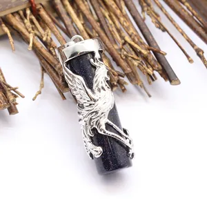 Macro detail of dark blue sandstone pendant featuring an intricate silver phoenix wrap