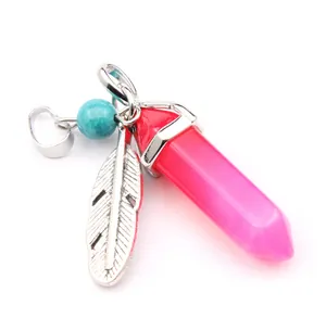 Detailed view of hexagonal pink agate pendant with silver feather and turquoise bead charm.