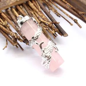 Close-up detail of a rose quartz crystal pendant featuring an intricate silver dragon wrap