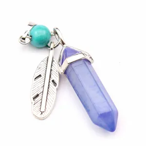 Detailed view of the purple hexagonal crystal point and silver feather charm pendant