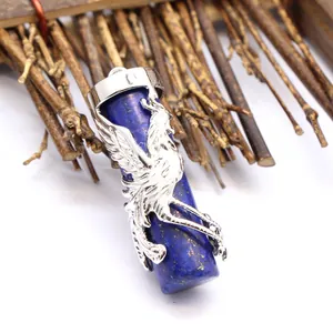 Detailed view of lapis lazuli cylinder pendant with intricate silver dragon design wrap.