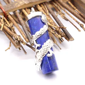 Macro detail of blue lapis lazuli cylinder pendant wrapped in a silver dragon motif