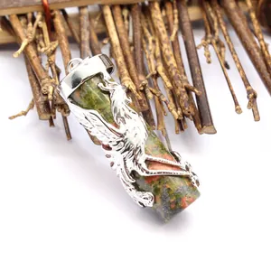 Close-up of Unakite stone pillar pendant with intricate silver dragon carving detail.