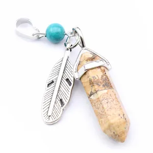 Detail view of hexagonal jasper pillar pendant with silver feather charm and turquoise bead.