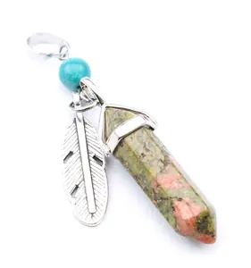 Detailed view of a hexagonal unakite crystal pendant with a silver feather charm