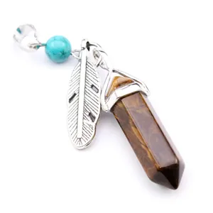 Detailed view of hexagonal Tiger Eye stone pendant with silver feather charm
