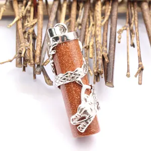 Detailed close-up of ethnic style silver dragon wrapped around brown goldstone pendant
