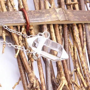 Close-up van een heldere zeshoekige kristallen hanger aan een zilverkleurige ketting