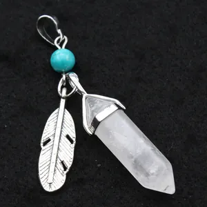 Detailed view of the hexagonal clear crystal pillar pendant with a silver feather.
