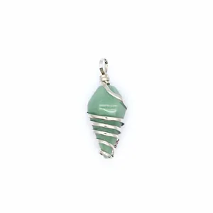 Detailed macro view of a hexagonal green crystal cone pendant wrapped in silver wire