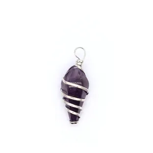 Detailed view of an amethyst hexagonal cone pendant wrapped in silver wire.
