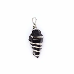 Detail view of the wire-wrapped hexagonal conical blue sandstone pendant