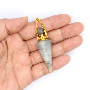 Detail view of a handcrafted labradorite crystal perfume bottle pendant held in hand