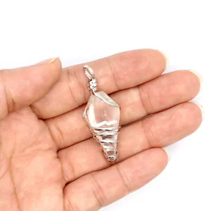 Detailed close-up view of a wire-wrapped hexagonal crystal cone pendant held in hand.