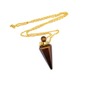 Close-up detail of a tiger eye stone hexagonal cone perfume bottle pendant on gold chain