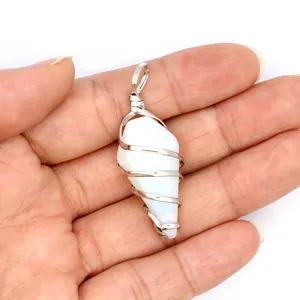 Close-up detail of a white hexagonal conical crystal pendant wrapped in silver plated wire.