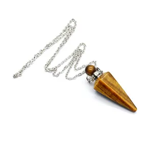 Macro detail of natural tiger eye crystal perfume bottle pendant with silver link chain