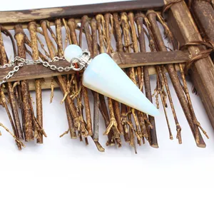 Macro detail of minimalist opal crystal cone pendant perfume bottle with silver chain.