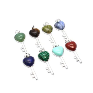 Detailed view of assorted heart-shaped key pendants made from various natural crystal stones